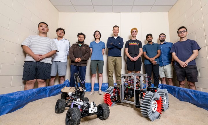 Team posing with rover simulation kit.