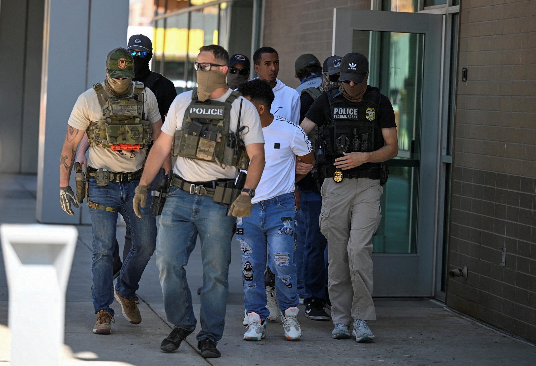 Law enforcement officers, including HSI and ICE agents, take people into custody at an immigration court in Phoenix, Arizona, U.S., May 21, 2025. REUTERS/Caitlin O'Hara TPX IMAGES OF THE DAY