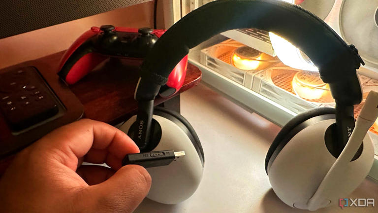A Sony Inzone H7 headset with its dongle switched to PS5 mode.