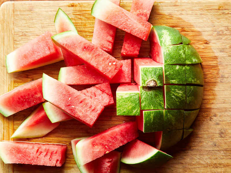 The watermelon slices lay on a cutting board.