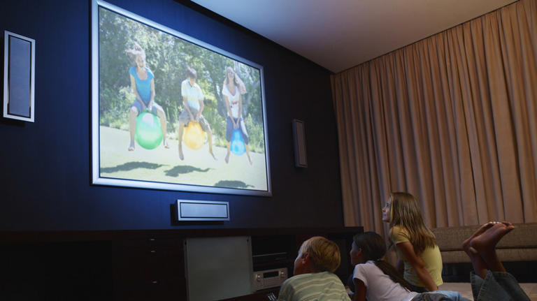 Family video played on TV screen with kids watching it