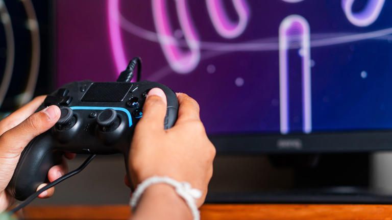 Black controller wired to TV