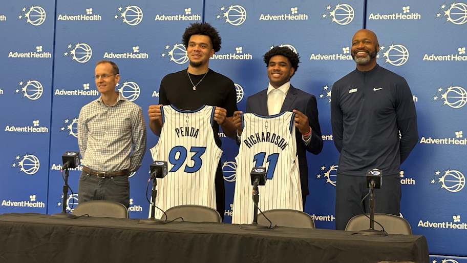 June 27, 2025: Jase Richardson and Noah Penda pose with Orlando Magic president of basketball operations Jeff Weltman and head coach Jamahl Mosley at an introductory Press Conference. | Jeremy Brener | Orlando Magic on SI
