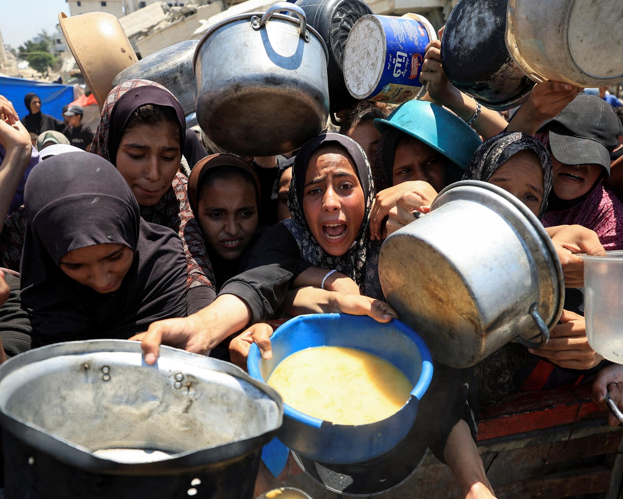 Palestinians clamour for food from a charity kitchen in Gaza City. Photograph: Dawoud Abu Alkas/Reuters
