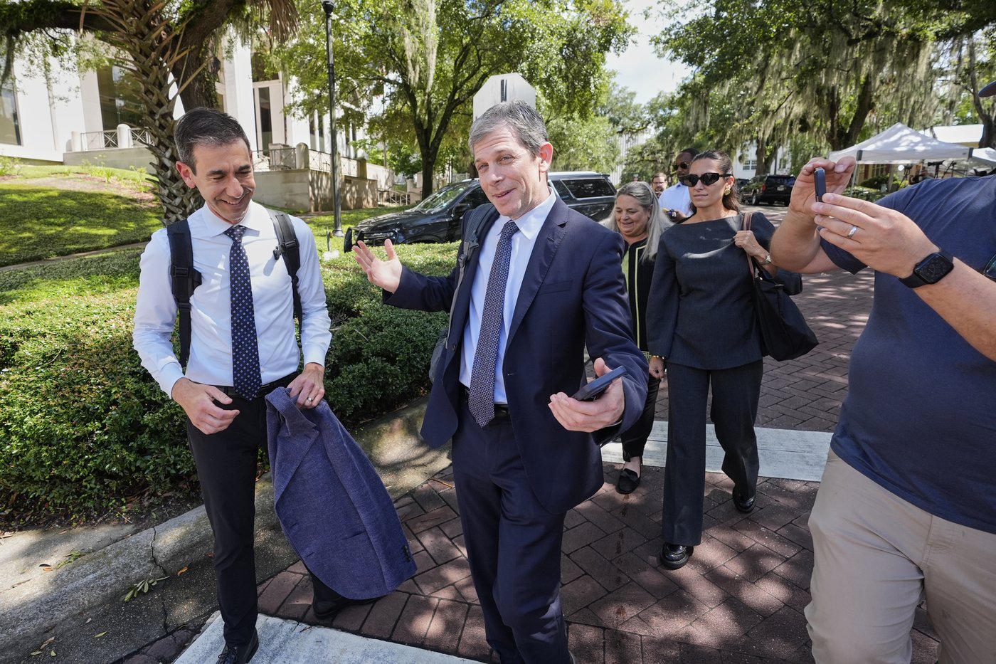 David Oscar Markus, attorney for Ghislaine Maxwell, center, is questioned by the media outside the federal courthouse in Tallahassee, Fla., Thursday, July 24, 2025. (AP Photo/John Raoux)