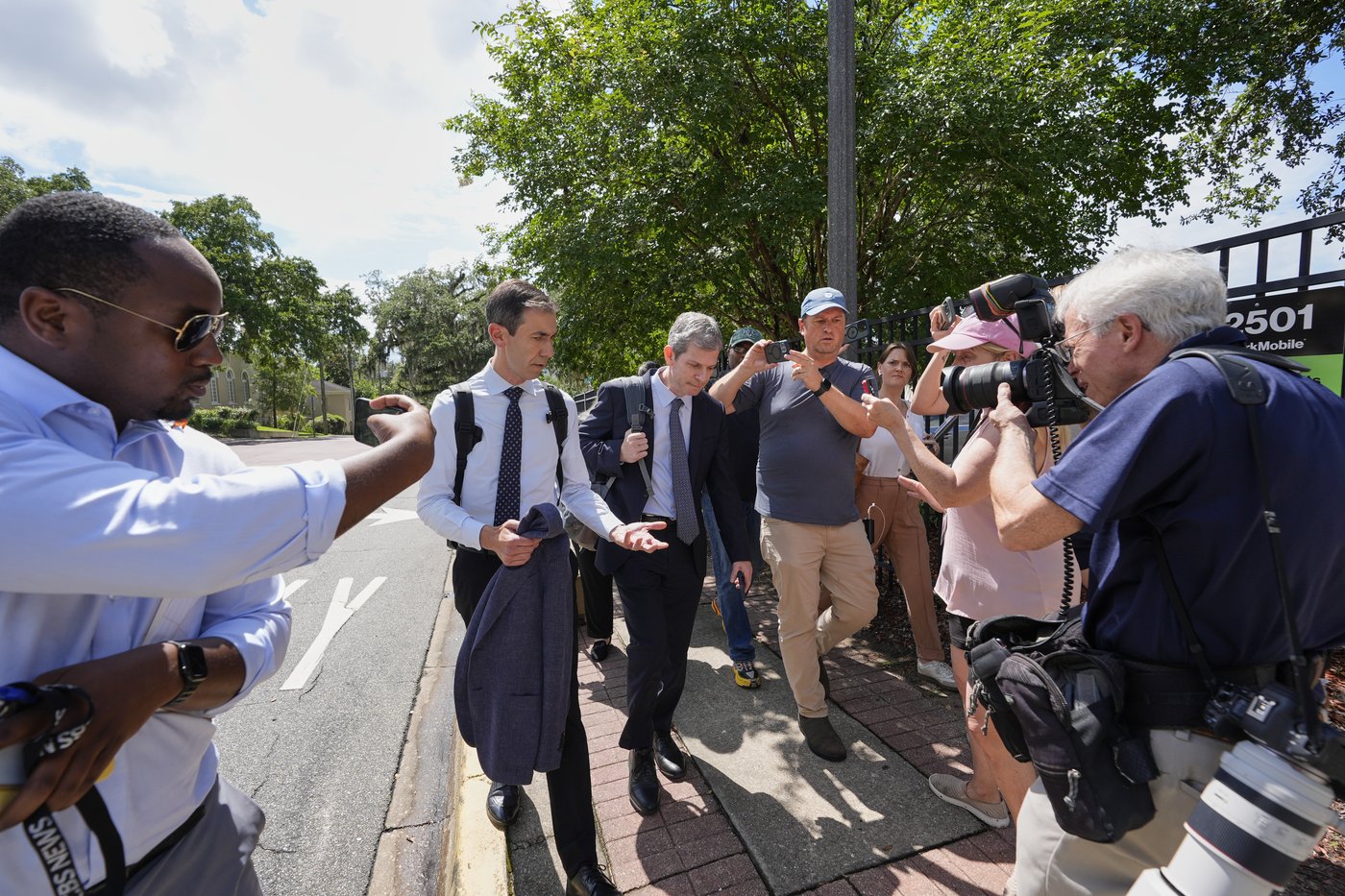 David Oscar Markus, attorney for Ghislaine Maxwell, center, is questioned by the media outside the federal courthouse in Tallahassee, Fla., Thursday, July 24, 2025. (AP Photo/John Raoux)
