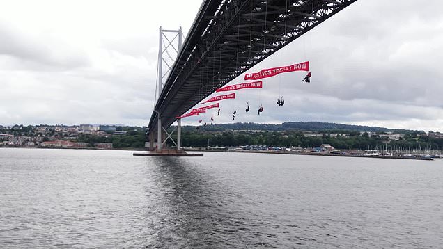 Terrifying moment Greenpeace protesters abseil Forth Road Bridge