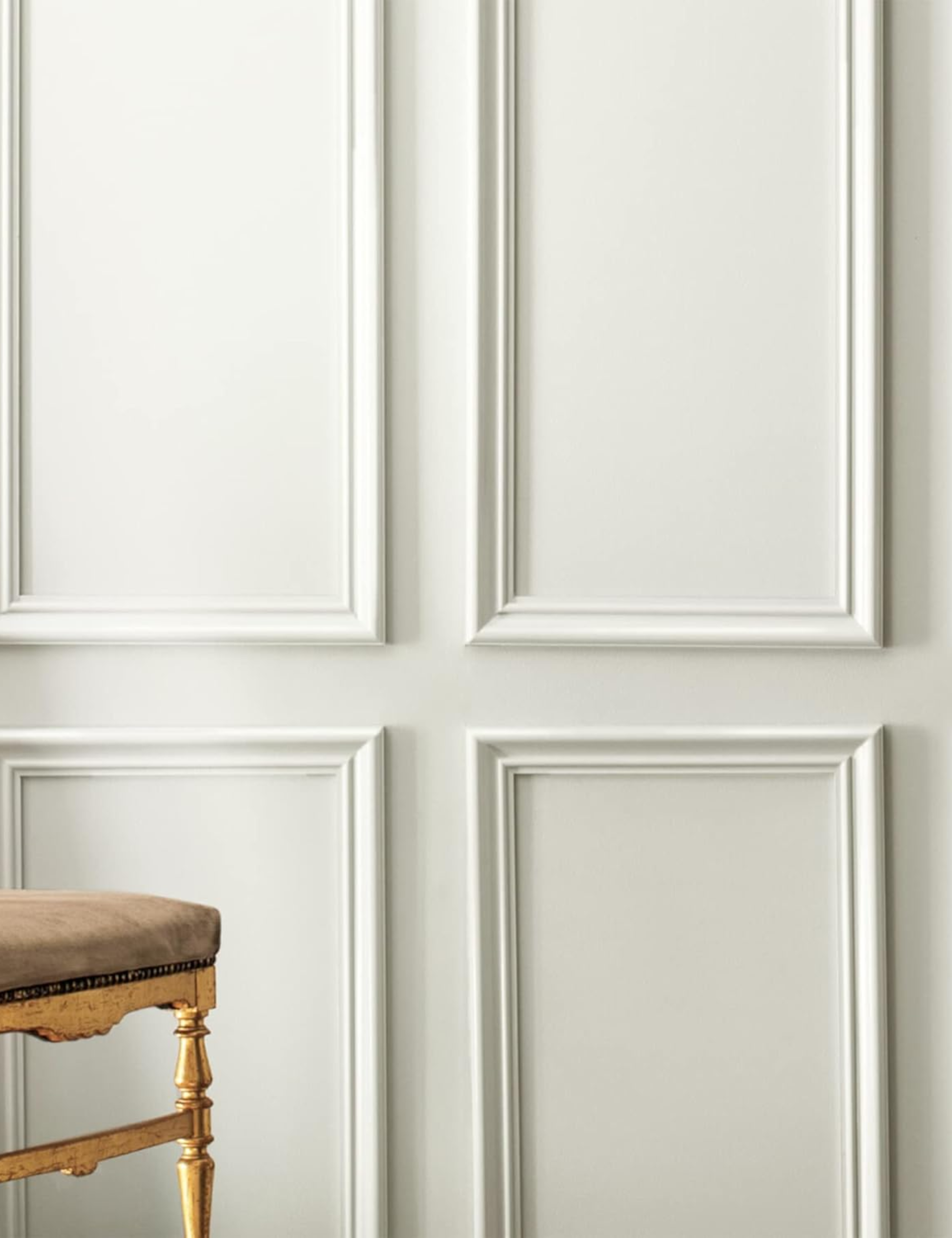 Stick on picture frame molding styled on a cream colored wall
