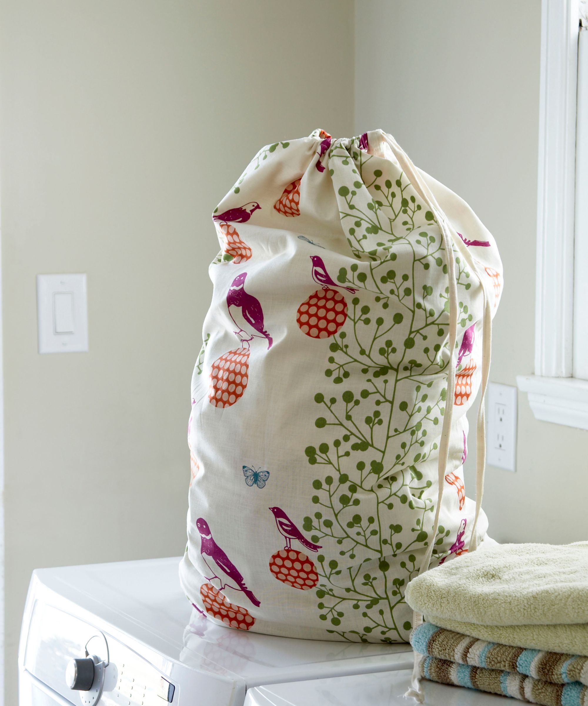A laundry bag on top of a washing machine