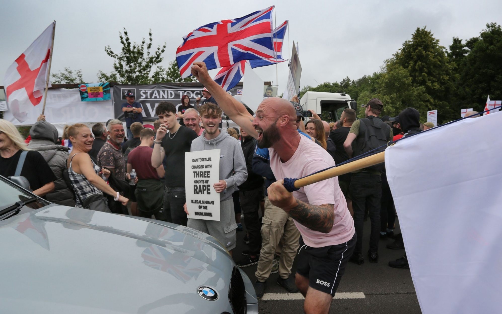 Flag-waving protesters outside the Brook Hotel in Norwich - Martin Pope/Getty Images