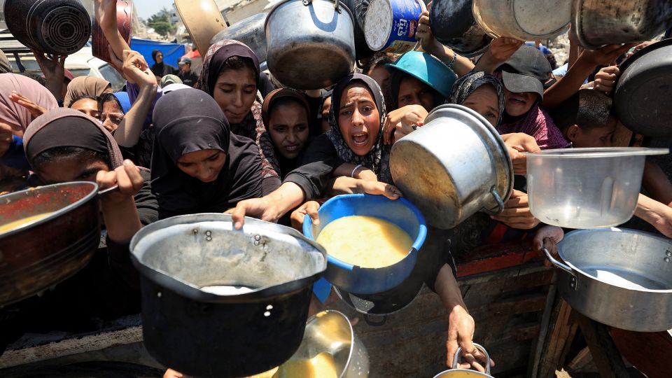 Palestinians gather to receive food from a charity kitchen, amid a hunger crisis, in Gaza City, on Thursday. - Dawoud Abu Alkas/Reuters