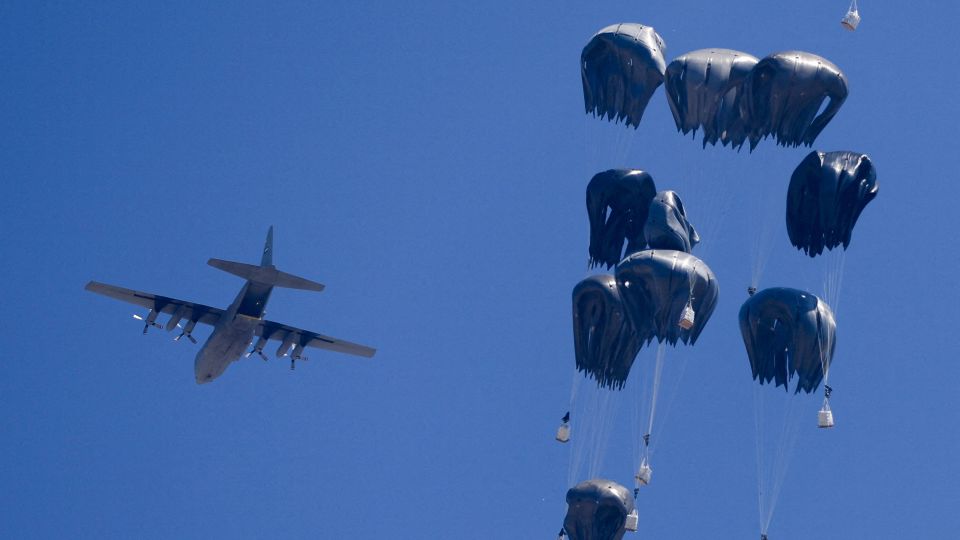 An airplane drops humanitarian aid over Gaza as seen from northern Gaza Strip on Sunday. - Dawoud Abu Alkas/Reuters