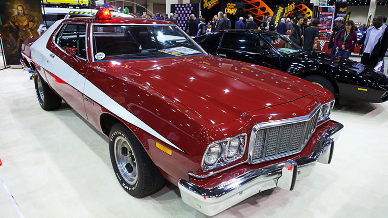 A red 'Starsky and Hutch' style Ford Torino on display at a show.