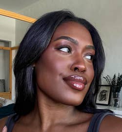 a dark kin reviewer with natural looking makeup