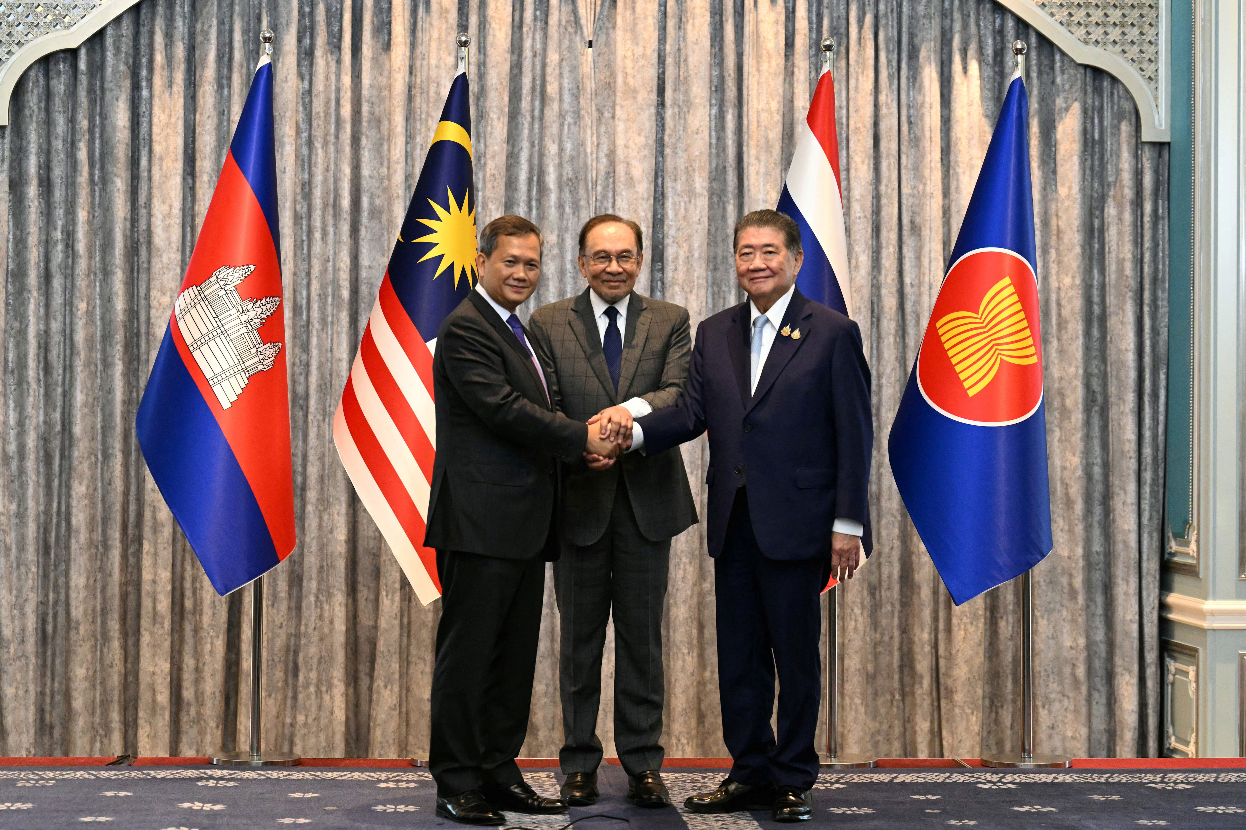 Malaysian prime minister Anwar Ibrahim, center, with Cambodia’s Hun Manet and Thailand's Phumtham Wechayachai (Reuters)