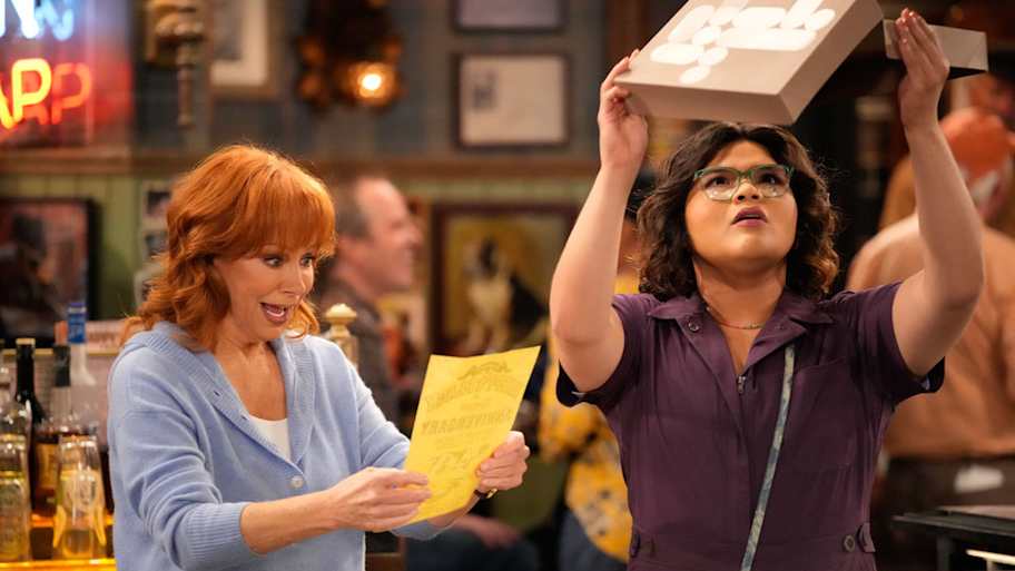 HAPPY'S PLACE -- "Emcee Squared" Episode 109 -- Pictured: (l-r) Reba McEntire as Bobbie, Belissa Escobedo as Isabella | NBC