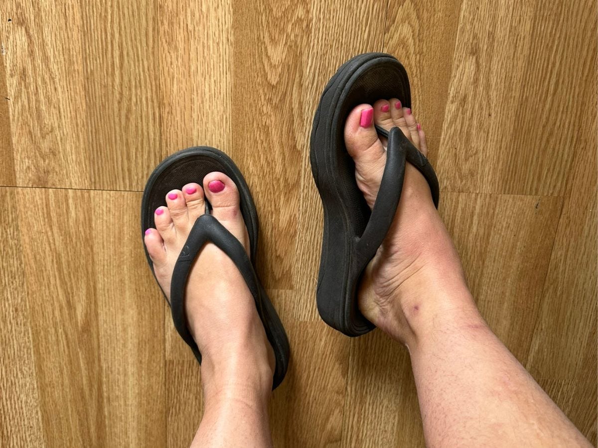 The author wearing black comfortable flip flops for women.