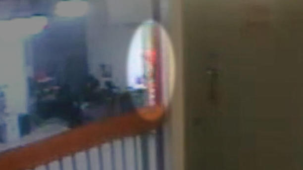 This image from the video — zoomed in and highlighted by CBS News – shows a partial view of something orange on the stairs leading to Jeffrey Epstein's cell tier.&nbsp; / Credit: U.S. Bureau of Prisons