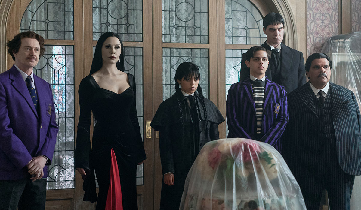 Wednesday. (L to R) Steve Buscemi as Barry Dort, Catherine Zeta-Jones as Morticia Addams, Jenna Ortega as Wednesday Addams, Isaac Ordonez as Pugsley Addams, Joonas Suotamo as Lurch, Luis Guzmán as Gomez Addams in episode 201 of Wednesday. Pic: Netflix