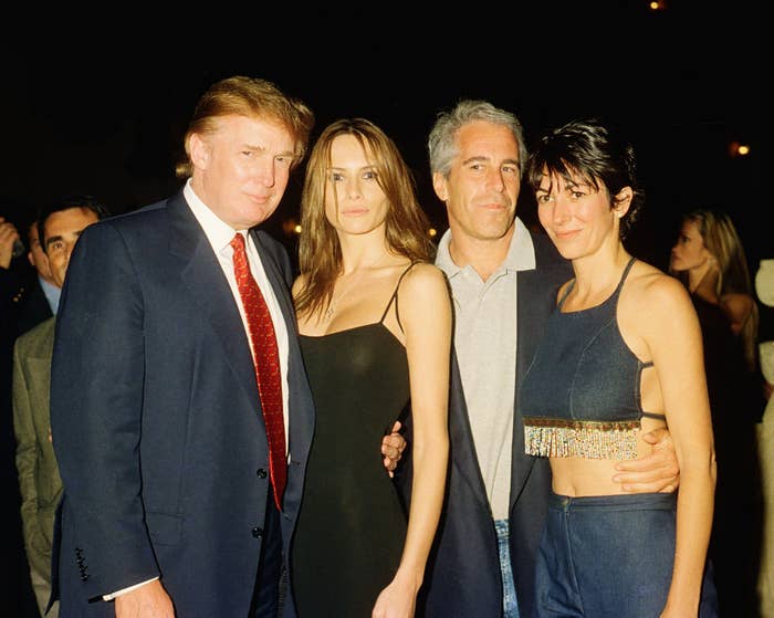 Four people pose at an event. The man on the far left is in a suit, the woman next to him wears a sleek dress, the others are casually dressed