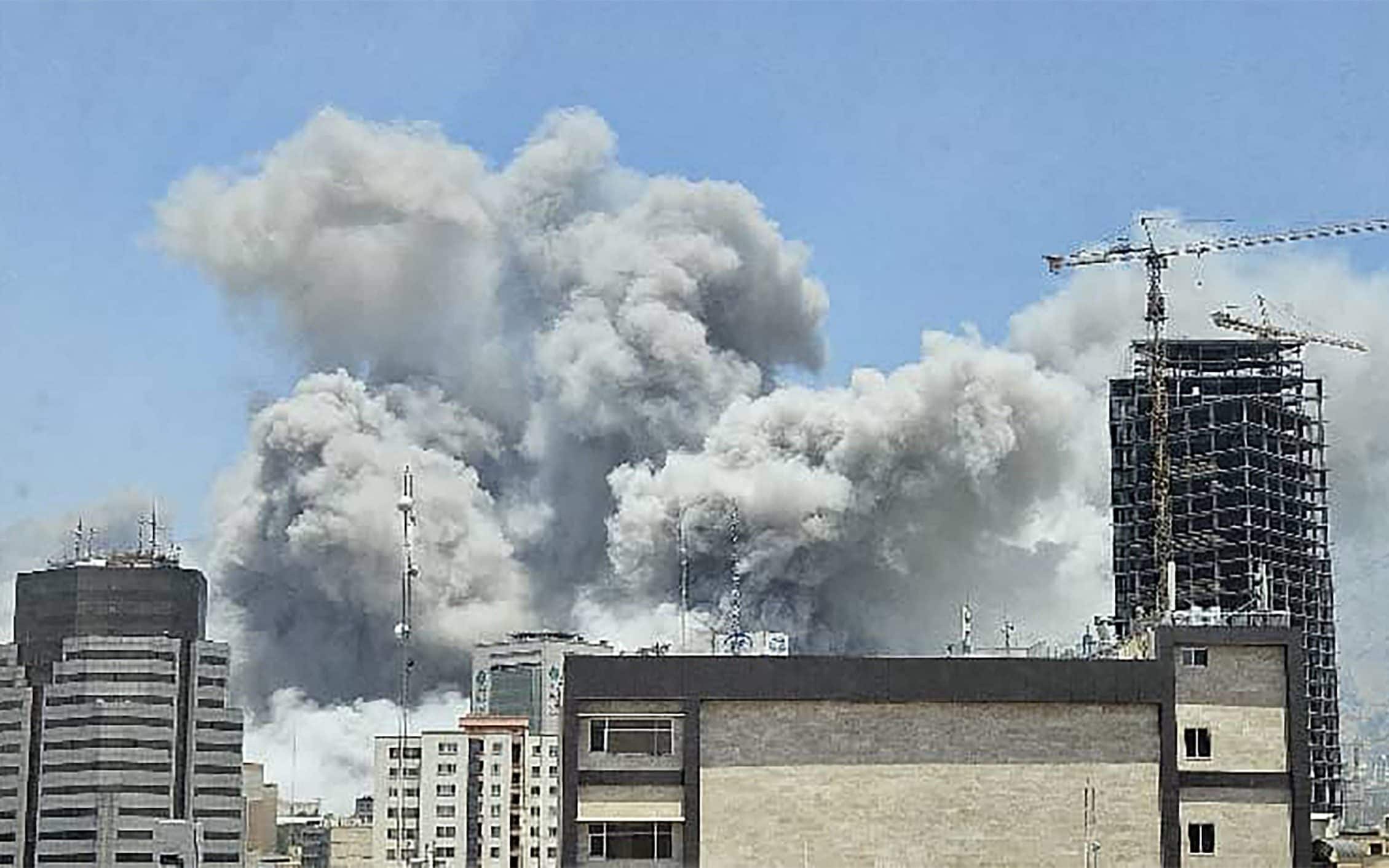 A plume of smoke billows after Israeli strikes in Tehran, June 23