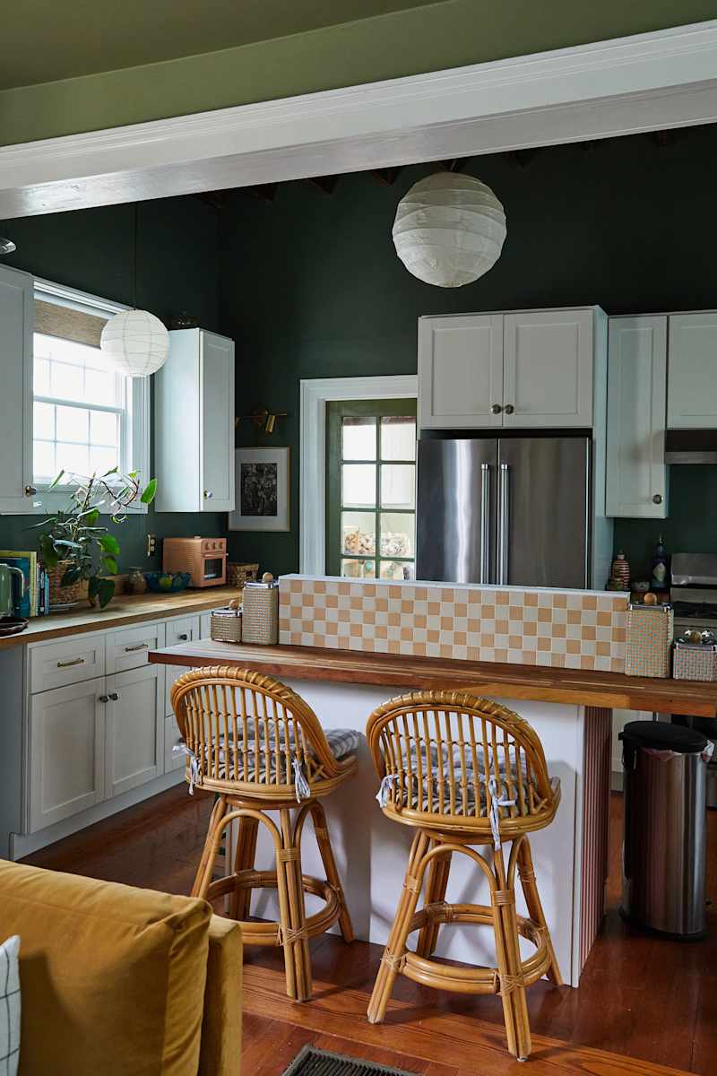 Rachel built and tiled this kitchen island "divider" to help hide the clutter that tends to accumulate on counter surfaces. Credit: Leela Cyd