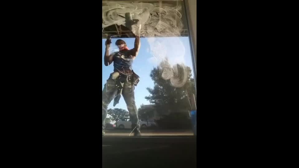 Guy Shows Off Smooth Skills While Cleaning Window
