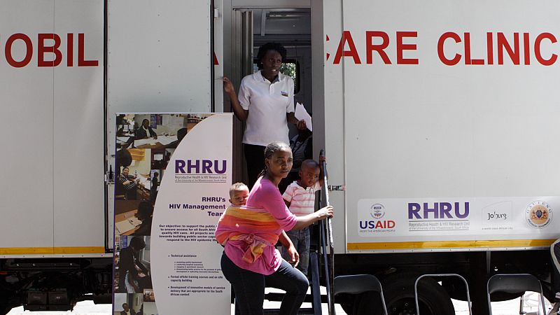 A woman enters a mobile healthcare clinic parked in downtown Johannesburg, South Africa.