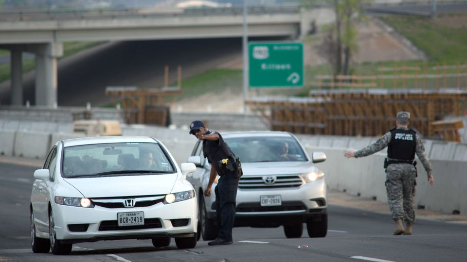 Local and military police direct traffic outside an entrance to Fort Hood following reports of an active shooting on the Texas base on April 2, 2014. - Tamir Kalifa/AP