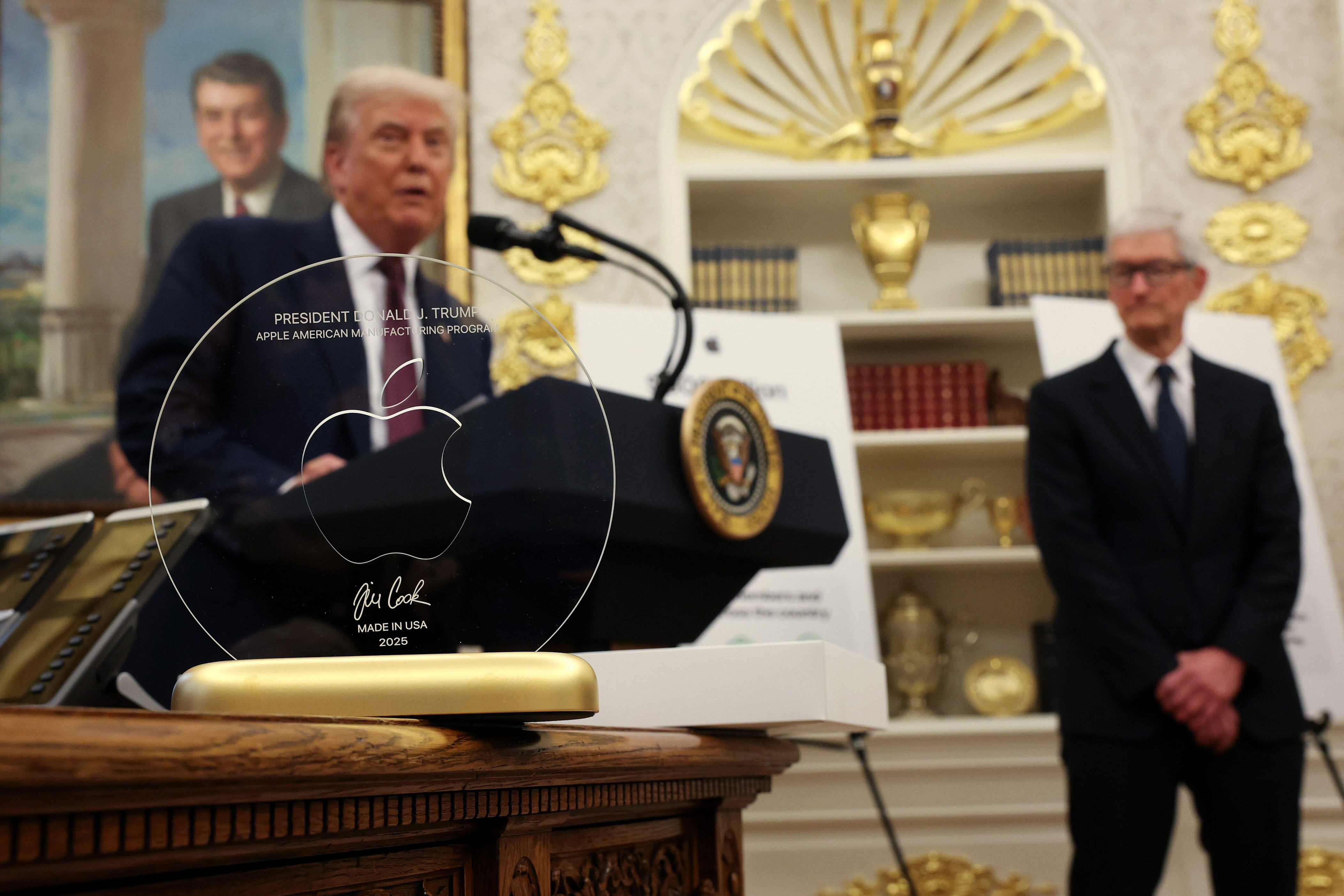 Tim Cook presented Trump with a tacky gold trophy in the Oval Office. / Win McNamee / Getty Images