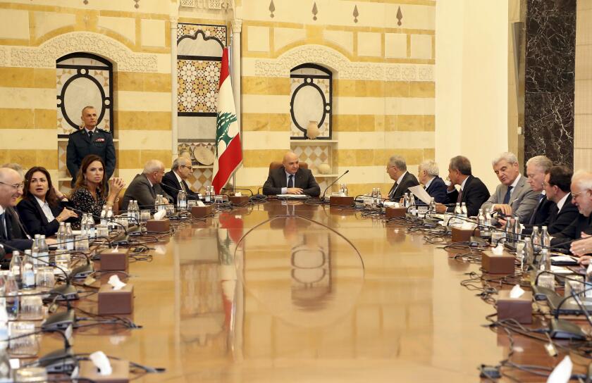 In this photo, released by the Lebanese Presidency press office, Lebanese president Joseph Aoun, centre, leads a Cabinet meeting which supposed to discuss the disarmament of Hezbollah, at the presidential palace in Baabda, east of Beirut, Lebanon, Thursday, Aug. 7, 2025. (Lebanese Presidency press office via AP)