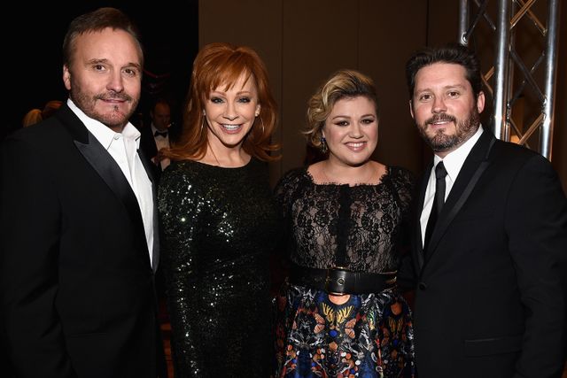 Narvel Blackstock, Reba McEntire, Kelly Clarkson and Brandon Blackstock attend Celebrity Fight Night XXI on March 28, 2015 in Phoenix, Arizona.