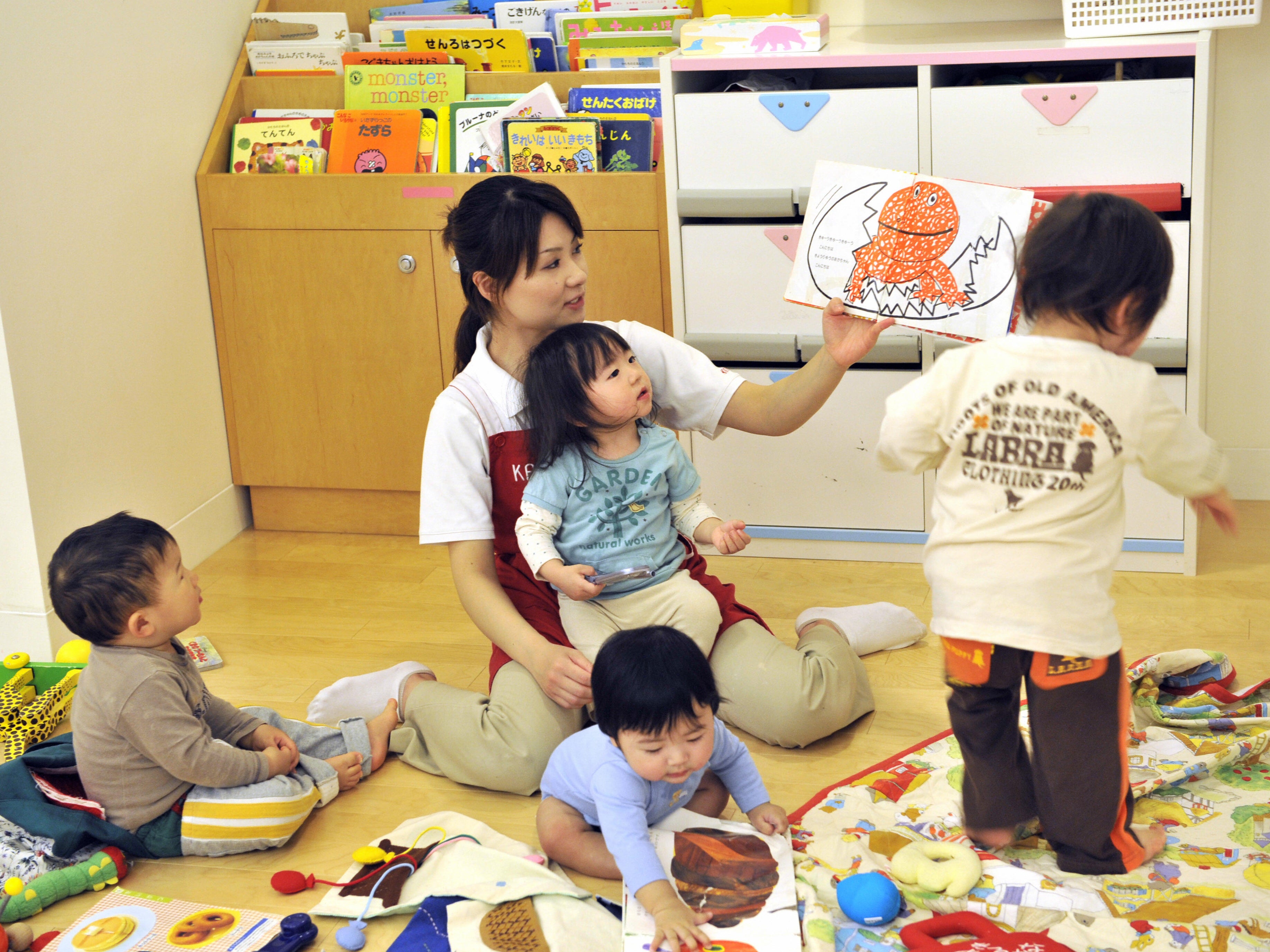 Children play in a nursery room run by Japanese cosmetics giant Shiseido in Tokyo on 2 April 2008 (AFP via Getty)