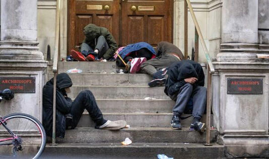 Group of rough sleepers on steps of Archbishop's house
