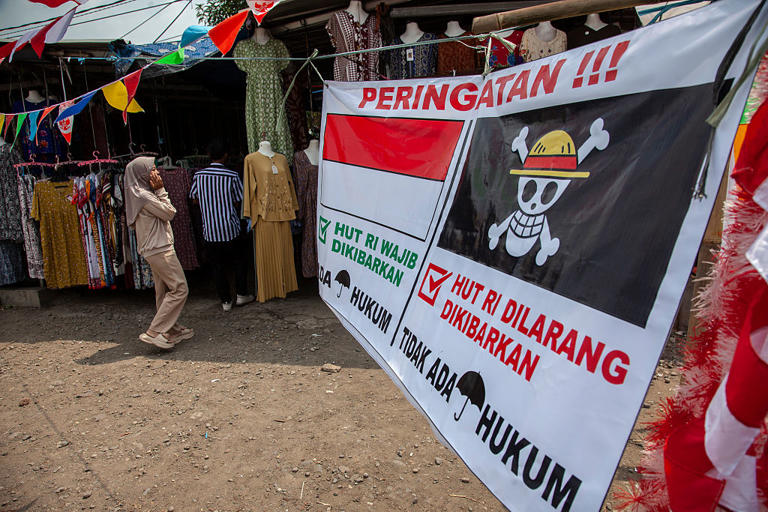 A banner warning Indonesians against flying the One Piece anime flag is displayed at a market in Indramayu, West Java province, on Aug. 9, 2025. Aditya Irawan—NurPhoto /Getty Images
