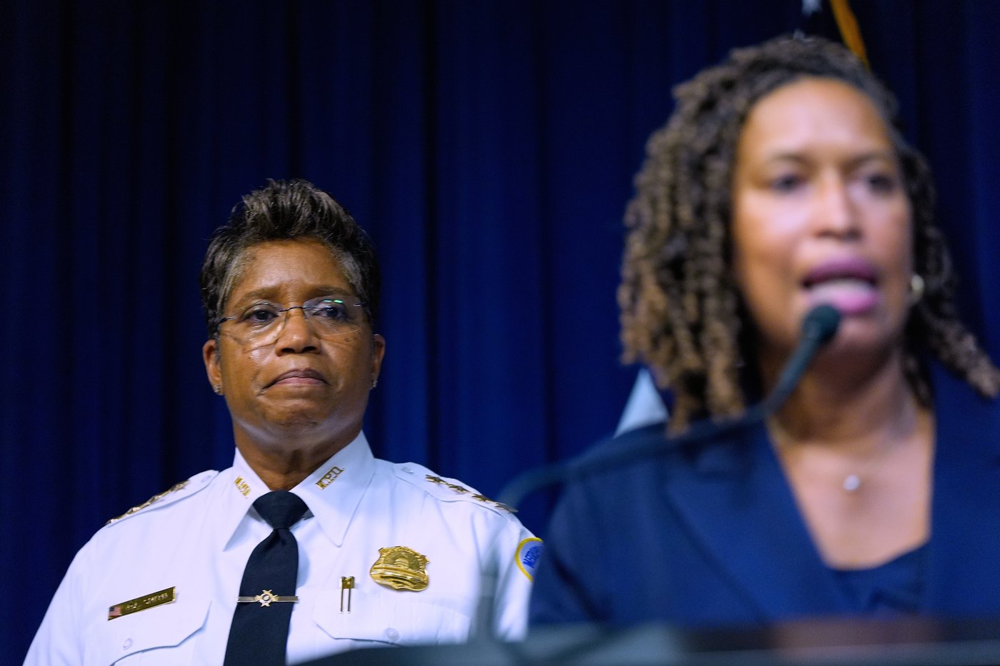 FILE - Metropolitan Police Department Chief Pamela Smith listens as Washington Mayor Muriel Bowser speaks during a news conference on President Donald Trump's plan to place Washington police under federal control and deploy National guard troops to Washington, Aug. 11, 2025, in Washington. (AP Photo/Julia Demaree Nikhinson, File)
