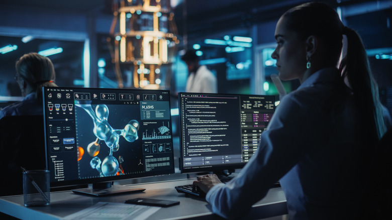 Woman studies a molecule using quantum computing.