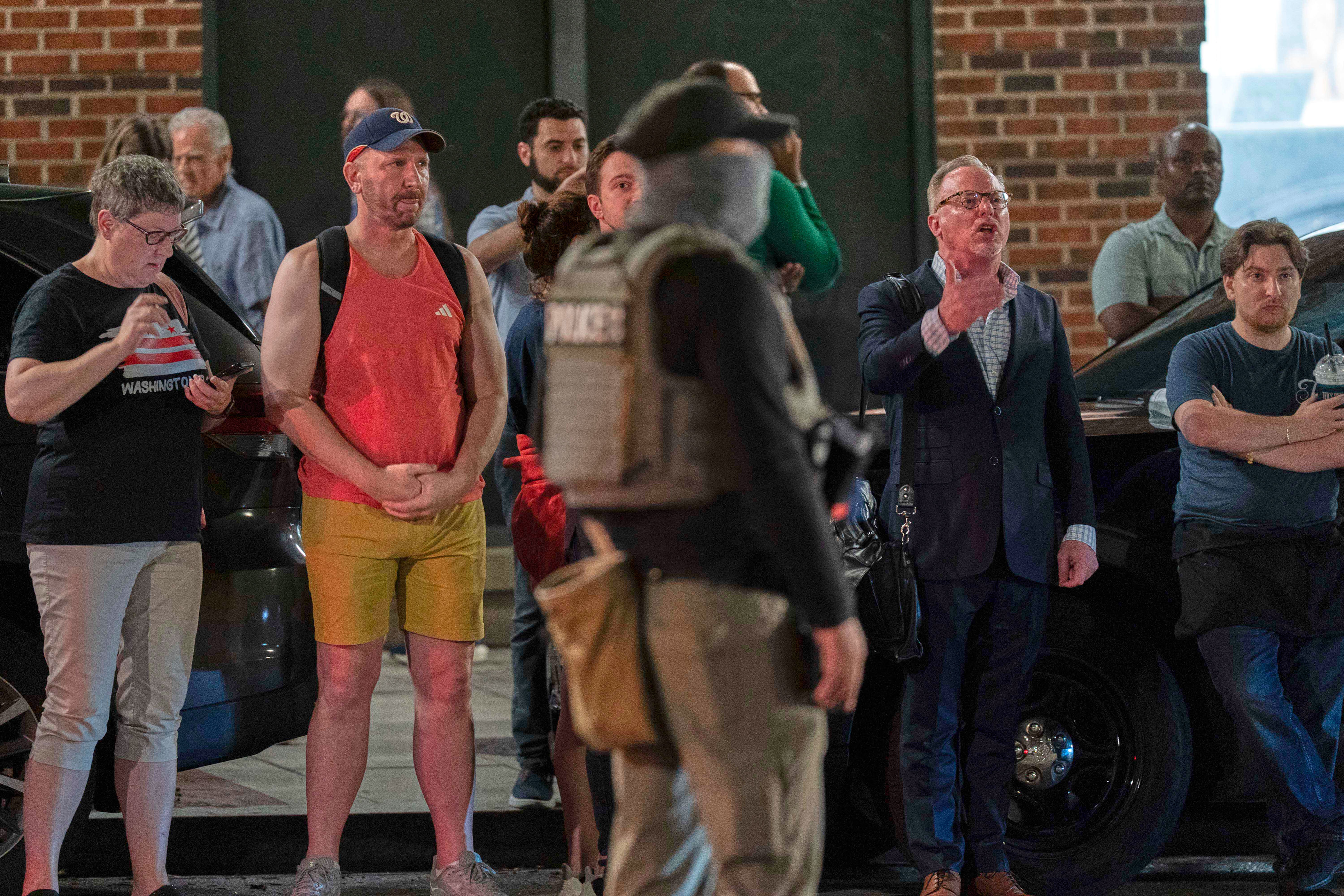 People yell at Department of Homeland Security agents as they joined D.C. police officers in conducting traffic checks along 14th Street NW on Wednesday. (Jose Luis Magana/AP)