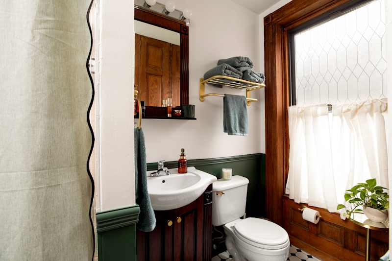"To ensure as much light as possible, I put up a frosted glass decal on the top of the window and a barn-door half curtain on the bottom half that I can swing out to open if I want some extra light," Sarah explains. Credit: Kiritin