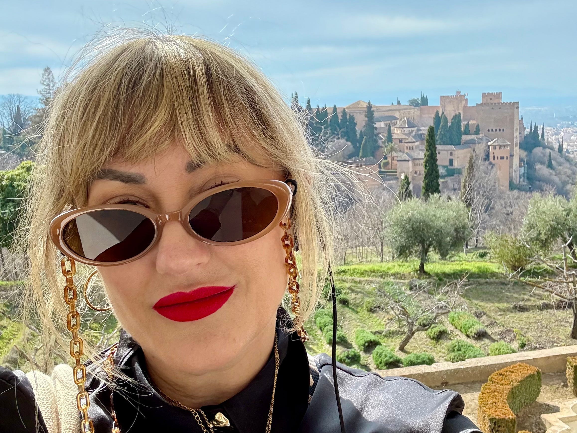 Michele Bennett in Spain, standing in front ofbuildings.
