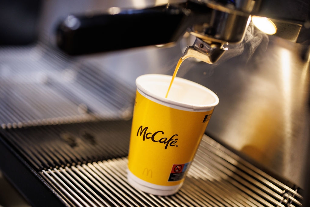 Coffee pouring into a McCafé cup from an espresso machine