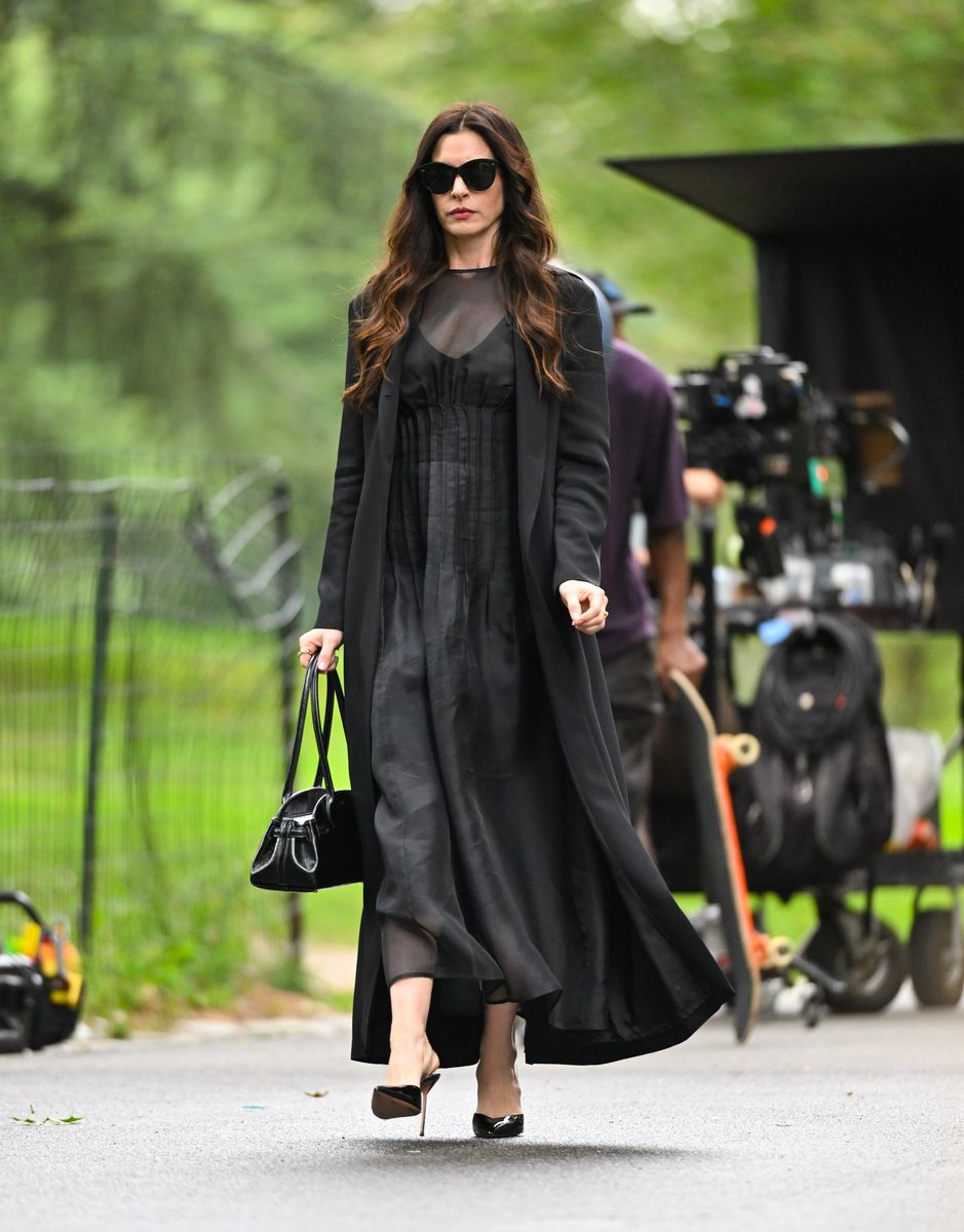 anne hathaway black dress Anne Hathaway Wears a Leather Mini Dress and Platform Boots at the Versace  Show in L.A