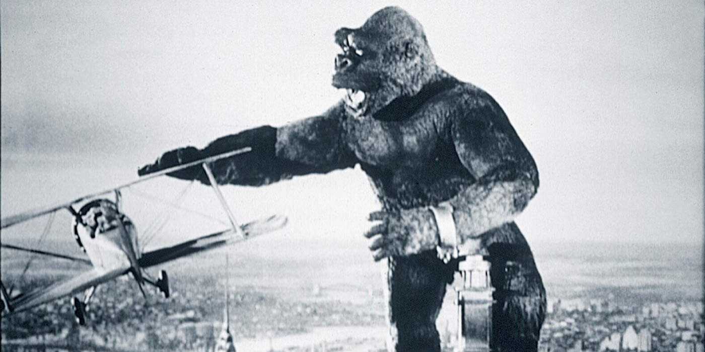 King Kong swipes at a plane from atop a building in King Kong