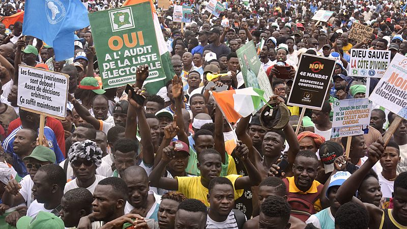 Demonstrators hold placards during a protest in Abidjan, Ivory Coast, Saturday, Aug. 9, 2025. (AP Photo/Diomande Ble Blonde)