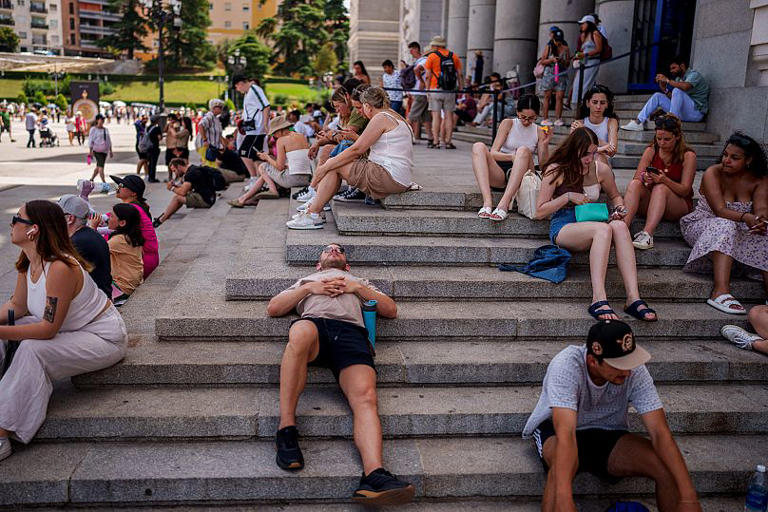 People rest during a hot and sunny day of summer in Madrid, Spain, Wednesday, July 19, 2023 AP Photo