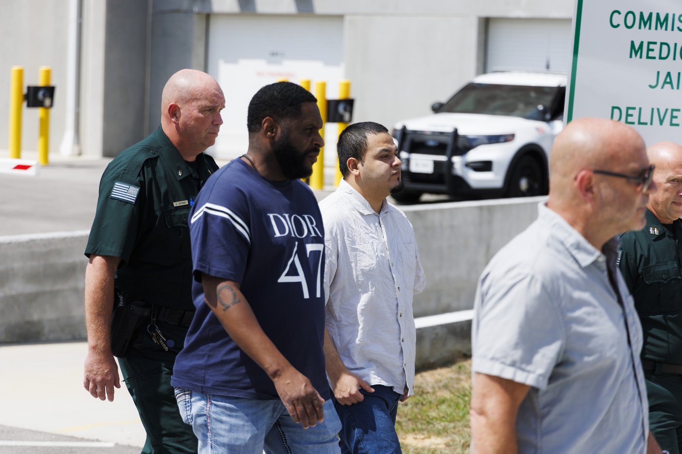 Kilmar Abrego Garcia, third from left, leaves the Putnam County Jail, Friday, Aug. 22, 2025, in Cookeville, Tenn. (AP Photo/Brett Carlsen)