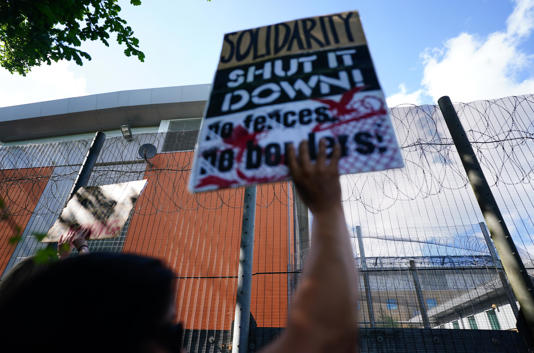 Migrant rights groups hold a show of support for people detained at Brook House Immigration Removal Centre at Gatwick who were scheduled to be sent to Rwanda, in June 2022 (PA)