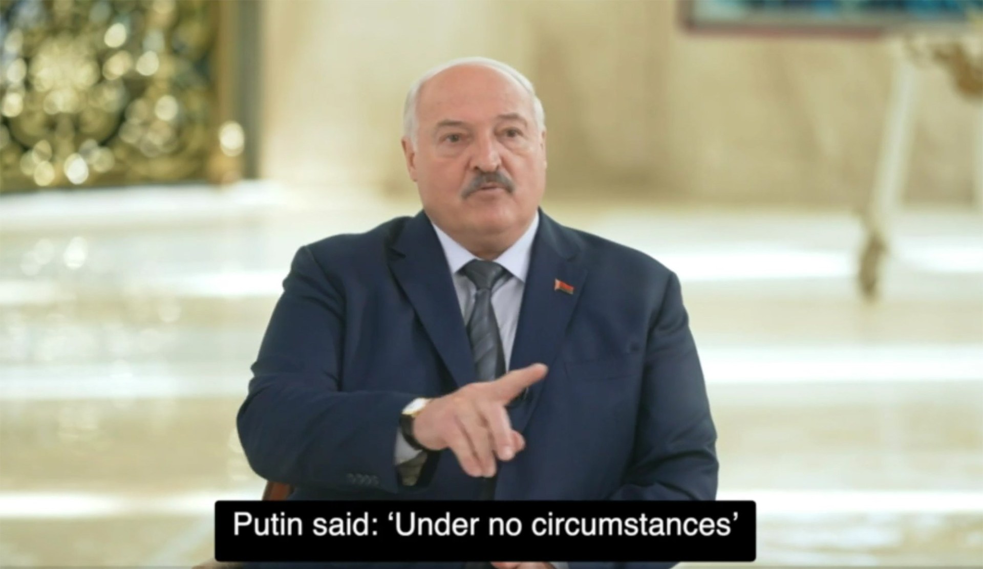 Alexander Lukashenko pointing towards reporters with the caption 'Putin said: 'under no circumstances'