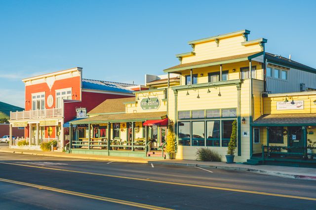 A view of buildings along the main street in Cayucos California featuring businesses with distinct architecture