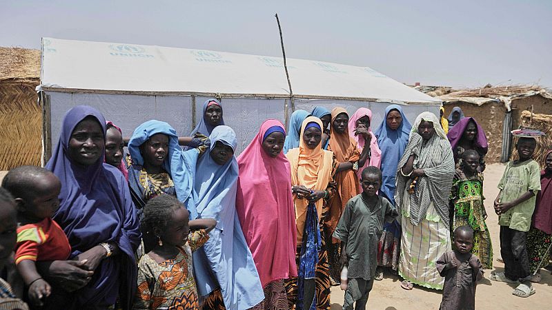 Women and children displaced by Boko Haram attacks are seen outside their camp in north-east Nigeria, 29 April 2025